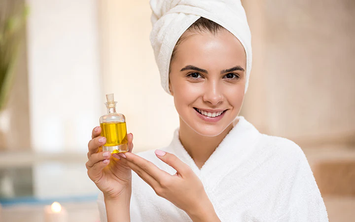 woman showing argan oil for healthy skin